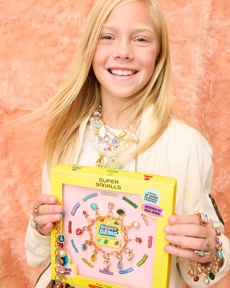 Girl holding birthstone charm bracelet in box